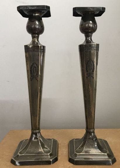 Pair of silver torches with a D in a coat...