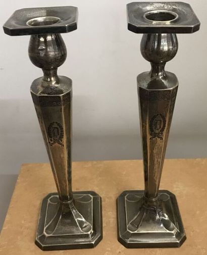 Pair of silver torches with a D in a coat...