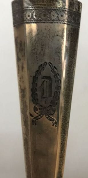 Pair of silver torches with a D in a coat...