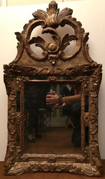 Wood and gilded paste mirror with parecloses,...