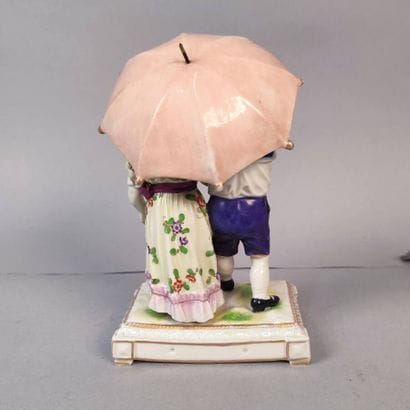 Group of couple of children under an umbrella...