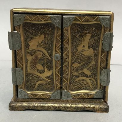 Small lacquered cabinet on a nashiji background,...