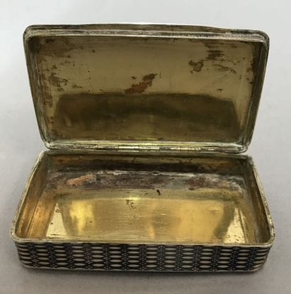 A copper and metal box decorated with characters...