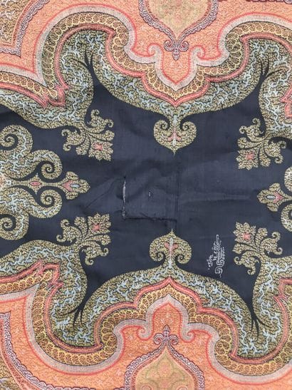 A fringed fabric with paisley on a red background
Height...
