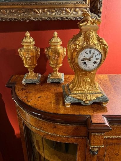 A chased and gilded bronze mantelpiece decorated...
