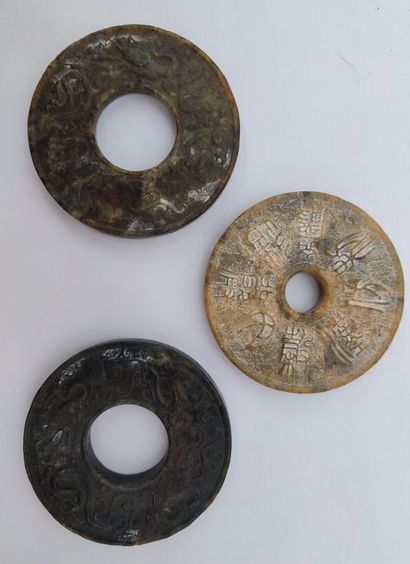 CHINA
Set of three bi jade discs in the archaic...
