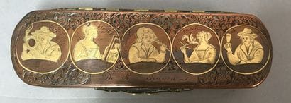 A copper and metal box decorated with characters...