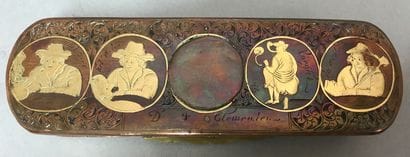 A copper and metal box decorated with characters...