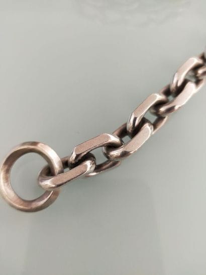 A silver bracelet with large links
Weight...