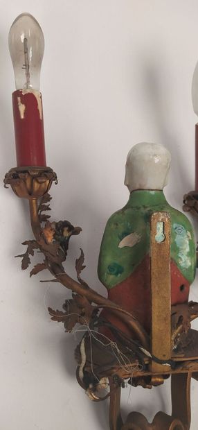 Pair of sconces in metal with subject in...