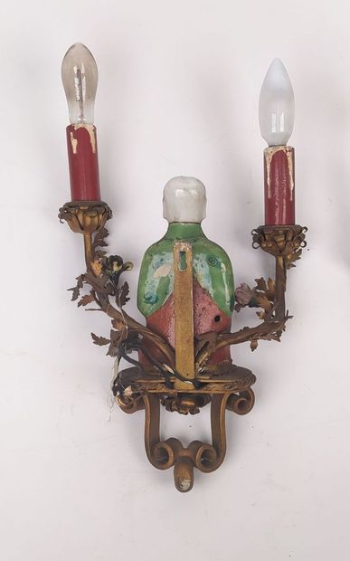 Pair of sconces in metal with subject in...