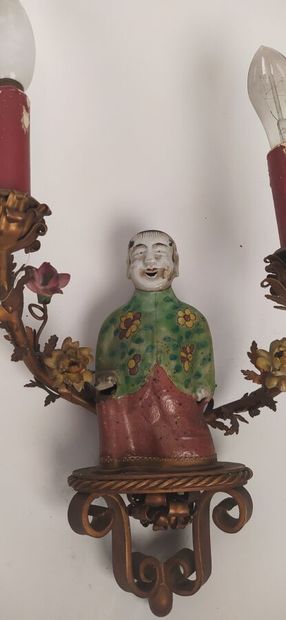 Pair of sconces in metal with subject in...