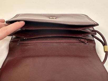 CARTIER -
Shoulder bag in burgundy leather,...