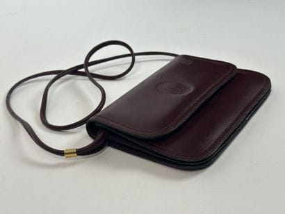 CARTIER -
Shoulder bag in burgundy leather,...
