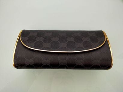 GUCCI
Evening clutch, gilded metal and black...