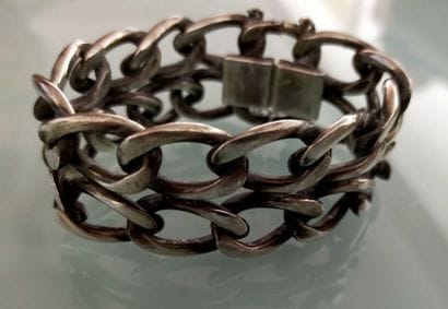 A silver bracelet with large links
Weight...