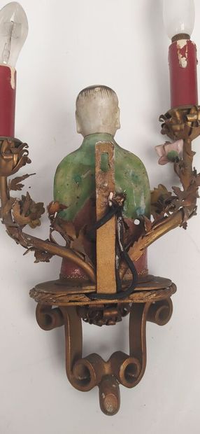 Pair of sconces in metal with subject in...