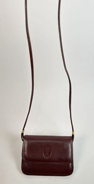 CARTIER -
Shoulder bag in burgundy leather,...