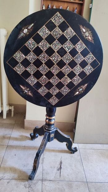 Set including a pedestal table with a black...