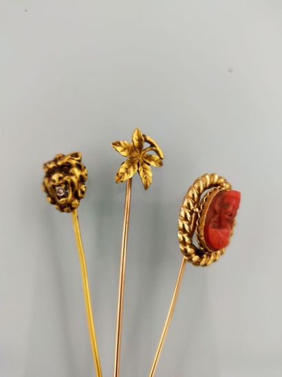 Two 18k gold tie pins and a third set with...