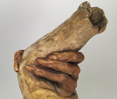 Terracotta sculpture of two embracing hands
Signed...