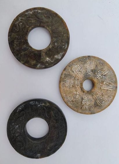 CHINA
Set of three bi-colored jade discs...
