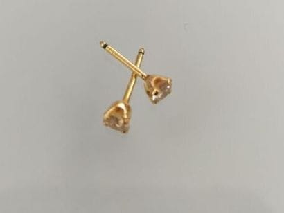 Pair of gold stud earrings
Each set with...