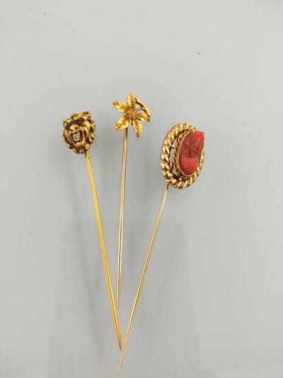 Two 18k gold tie pins and a third set with...