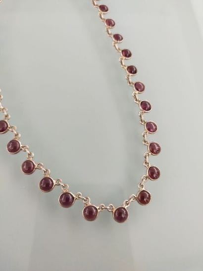 Silver necklace adorned with garnet cabochon...
