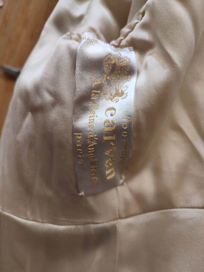 CARVEN
Mid-length, belted coat in cream astrakhan...