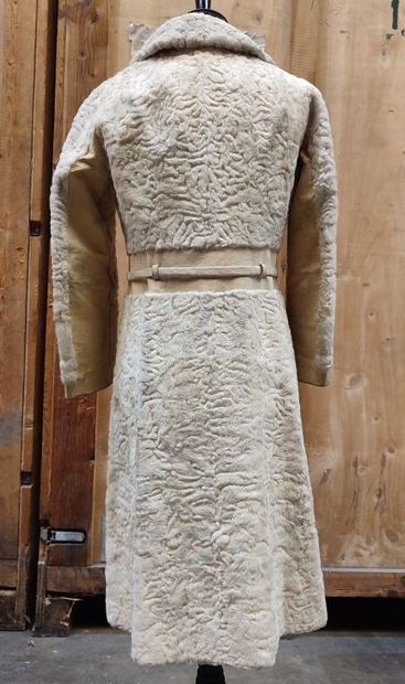 CARVEN
Mid-length, belted coat in cream astrakhan...