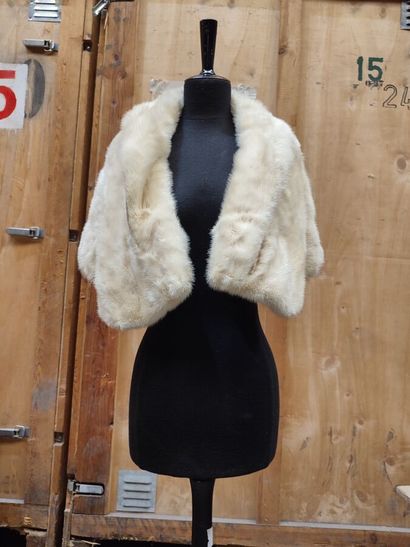 CARVEN
Mid-length, belted coat in cream astrakhan...