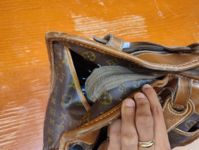 LOUIS VUITTON
Set of three small travel bags:...