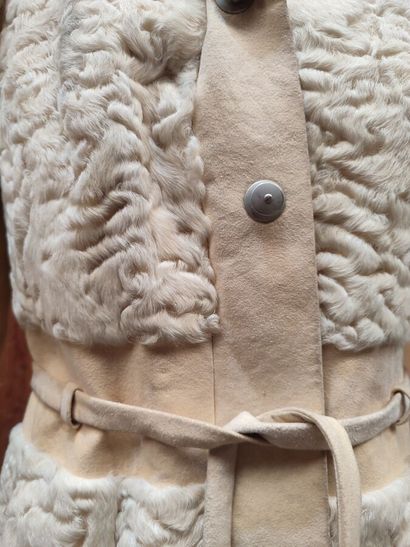 CARVEN
Mid-length, belted coat in cream astrakhan...
