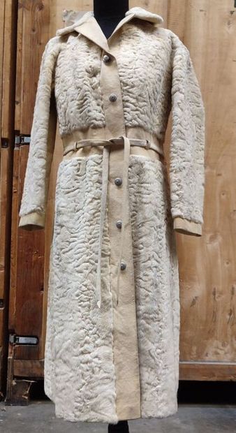 CARVEN
Mid-length, belted coat in cream astrakhan...