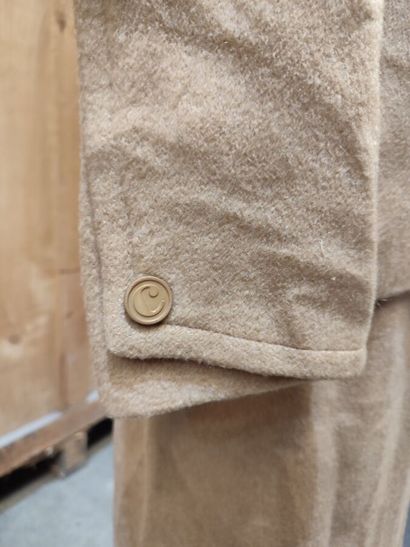CARVEN
Beige ensemble with belted jacket,...