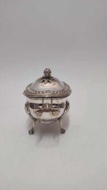 A quadripod sugar bowl with handles in silver...
