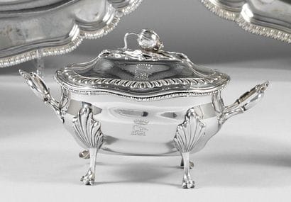 A quadripod sugar bowl with handles in silver...