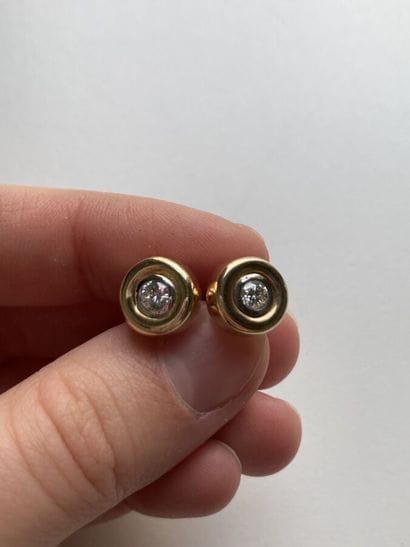 Pair of yellow gold stud earrings set with...