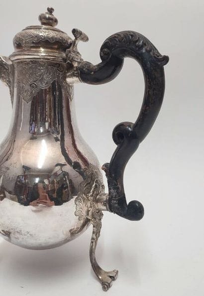 Silver tripod coffee pot, with scrolled feet...