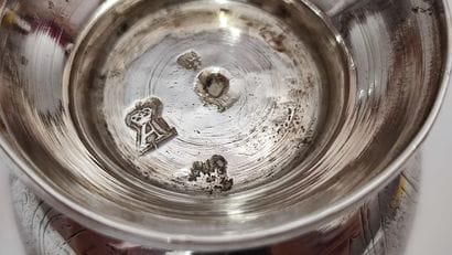 A silver tulip-shaped kettledrum decorated...