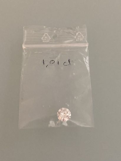 Round brilliant-cut diamond on paper.
Accompanied...