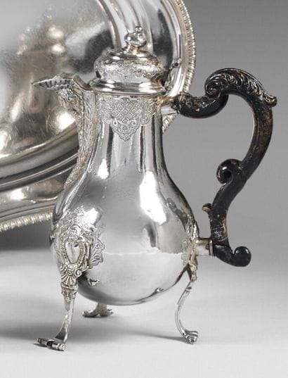 Silver tripod coffee pot, with scrolled feet...
