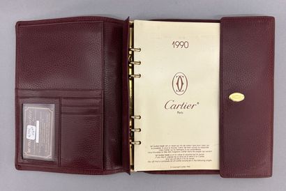 Must by CARTIER
Two large burgundy leather...