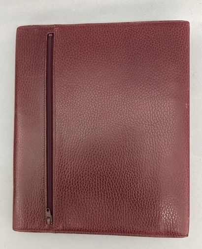 Must by CARTIER
Two large burgundy leather...