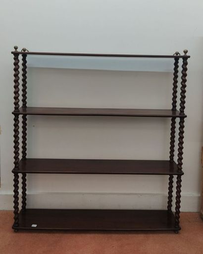 Wall-mounted bookshelves with turned wood...
