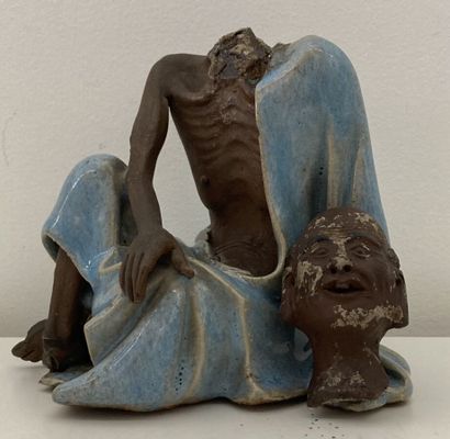 Stoneware figure, blue enamel tunic
Height...