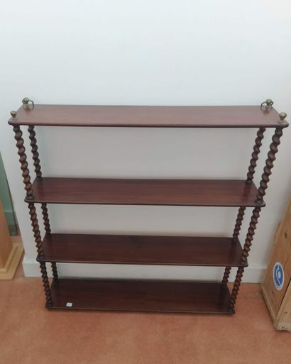 Wall-mounted bookshelves with turned wood...