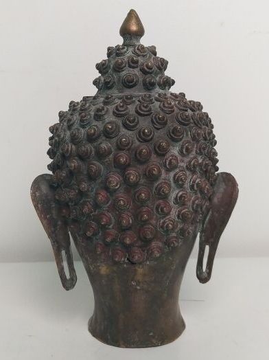 Gilded bronze Buddha head, adorned with an...
