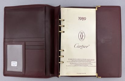 Must by CARTIER
Two large burgundy leather...